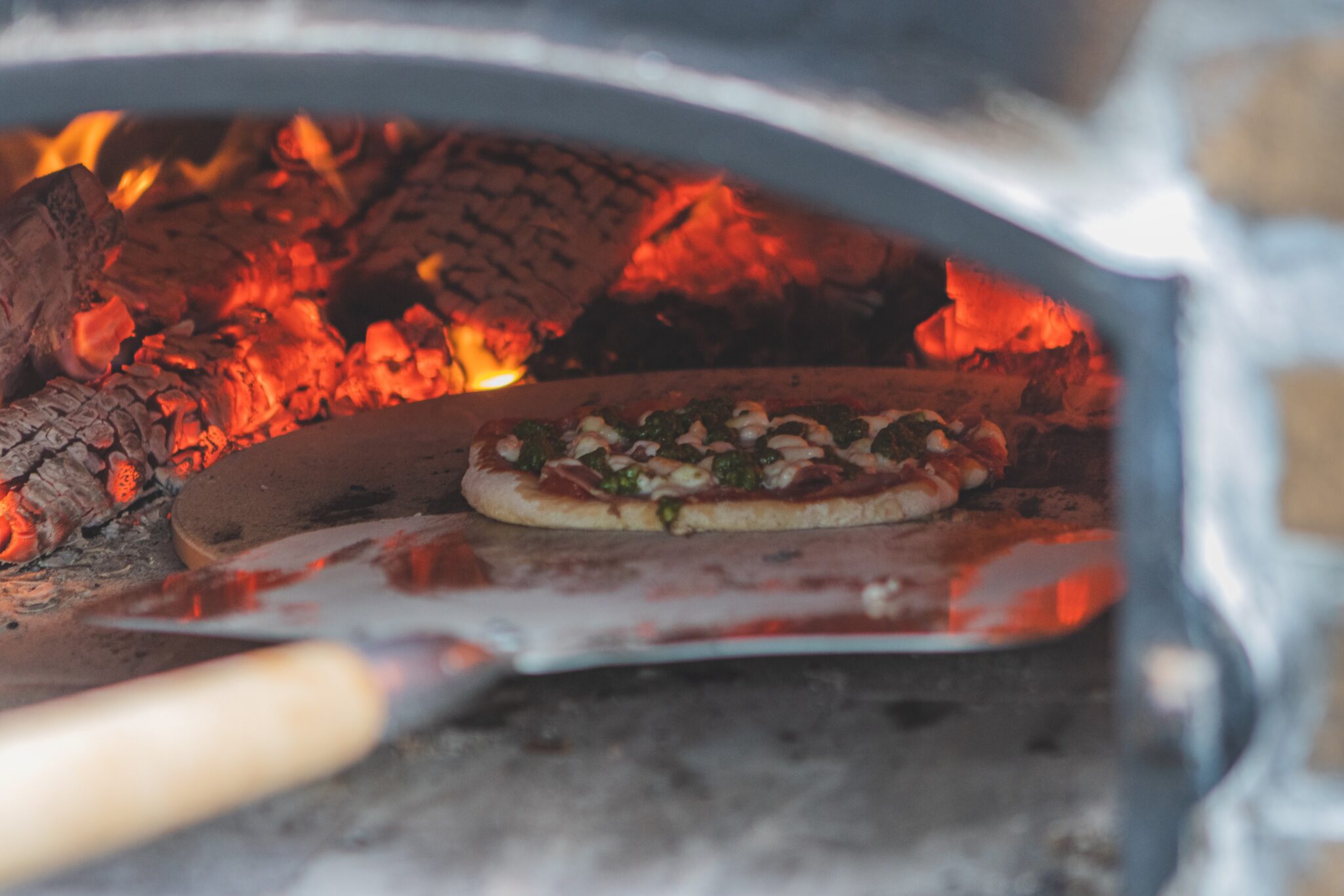 pizza going into wood oven